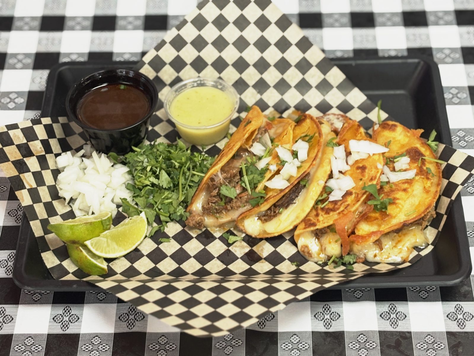 Quesabirria tacos with melted Monterrey Jack cheese and consomé